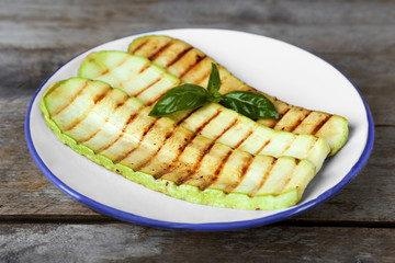 Grilled vegetable mallow in white plate on wooden table, closeup