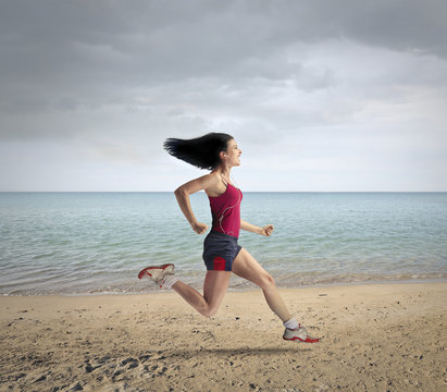 Young woman running at the beach