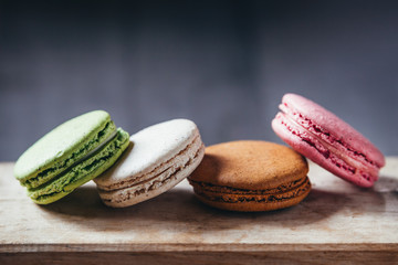 Colourful tasty macaroons on a wooden table