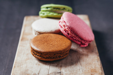 Colourful tasty macaroons on a wooden table