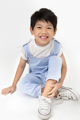 Little asian boy with smile face on gray background