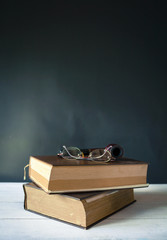 Eyeglasses and smoking pipe on old dictionary