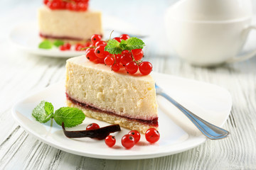 Delicious cheesecake with berries on table close up