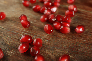 Naklejka na ściany i meble Juicy pomegranate on wooden table, closeup