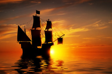 Old ancient pirate ship on peaceful ocean at sunset.