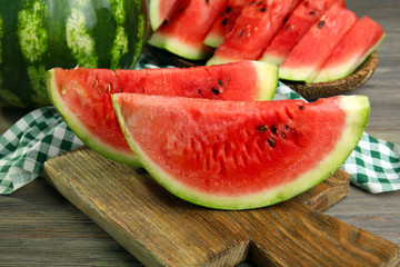Slices of ripe watermelon on wooden table close up