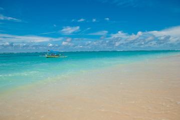 Fototapeta na wymiar A lone boat on a tropical beach in Bali