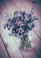 statice flower bouquet  on wood background - soft focus with vin