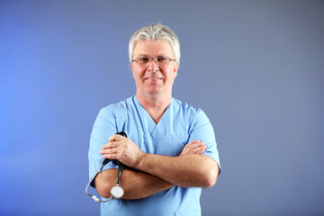 Doctor with stethoscope on colorful background