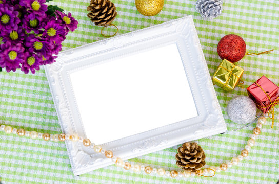 Vintage white photo frame with christmas decoration with flower.