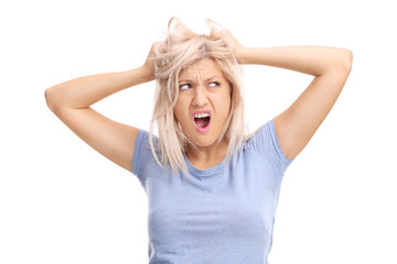 Frustrated woman pulling her hair and screaming