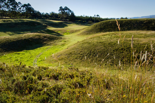 Ruins of Cochasqui pyramids, archaeological site, with Cotopaxi in the background, Ecuador