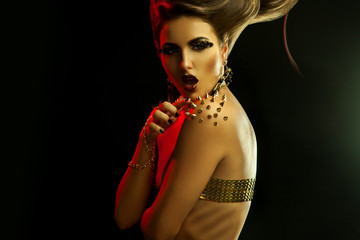 Seduction young girl with creative hairstyle and golden accessor