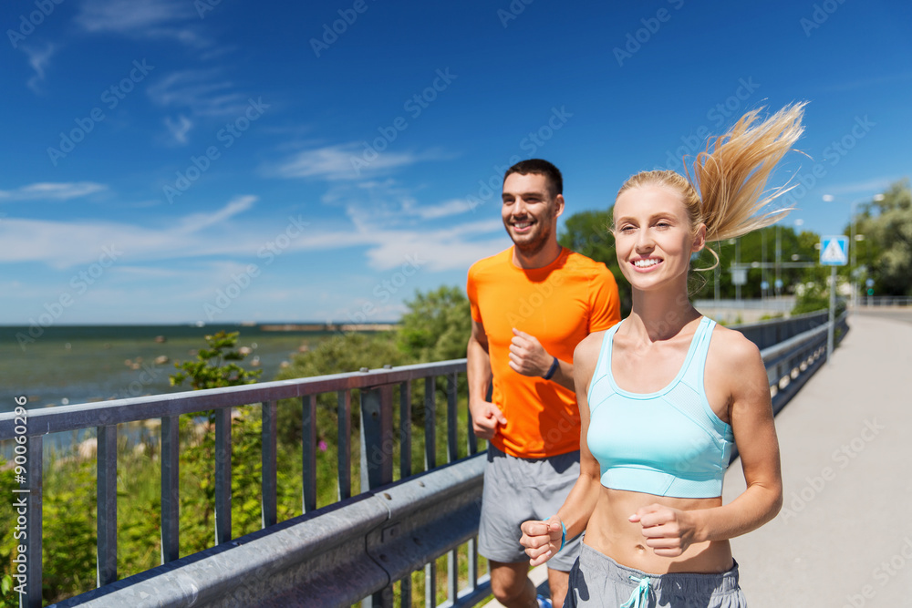 Poster smiling couple running at summer seaside