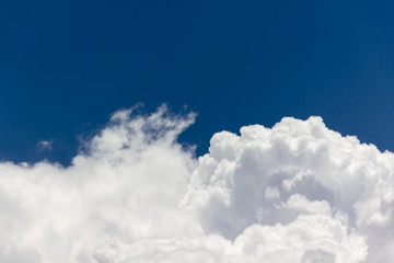 Fototapeta na wymiar beautiful big puffy white clouds in light cheerful light blue sky with fresh feeling