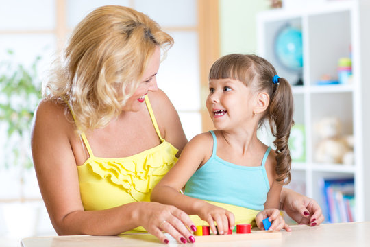 mother and child play together with educational toys