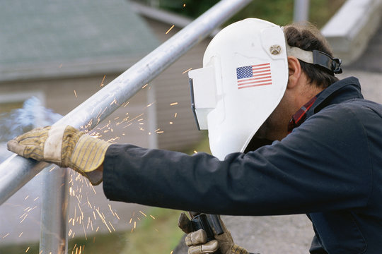 Man welding steel railing