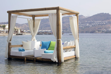 pergola white cushions and curtains in the sea romantic