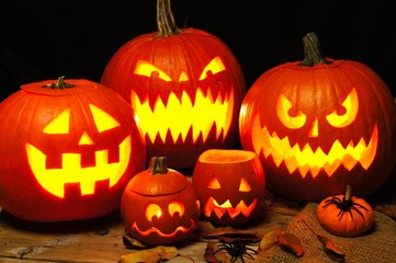Halloween night scene with a group of spooky illuminated Jack o Lanterns