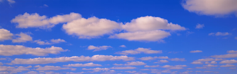 Puffy white clouds against bright blue sky