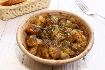 Fototapeta premium Braising meat with Italian herbs