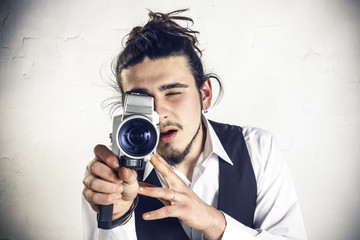 Young man using a vintage camera
