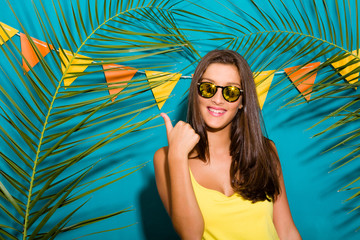 Portrait of young pretty brunette with mirror sunglasses. With thumbs up gesture