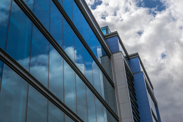Fototapeta na wymiar Contemporary Urban Building with Glass Window Reflection