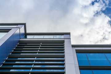 Upright Modern Office Building with White Clouds
