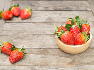 Fresh red strawberry in a wooden bowl