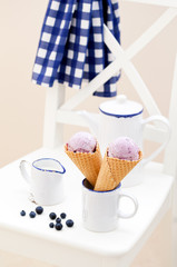 Blueberry ice cream in waffle cones, selective focus