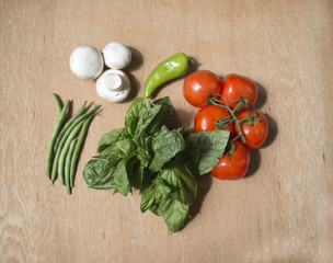 Champignon, hot peppers, yellow pepper, red tomato, savoy on wood background