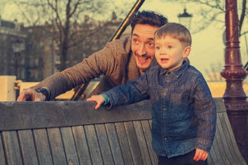 Father and son watching the sunset together