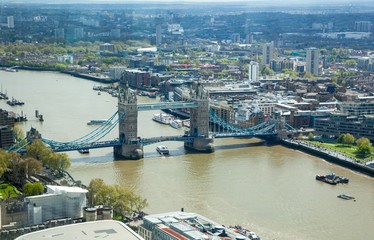 Obraz premium LONDON, UK - APRIL 15, 2015: City of London panorama at sunset. Tower bridge and River Thames