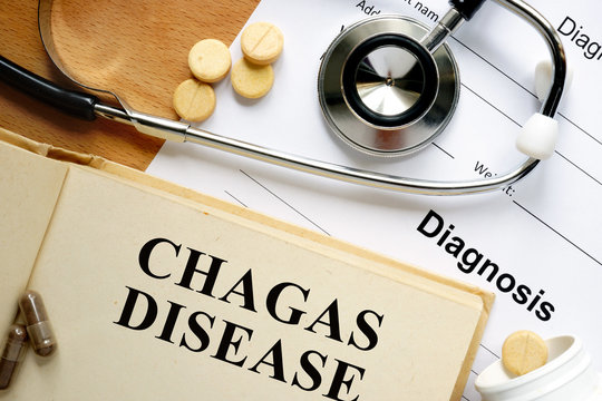Word Chagas Disease  on a paper and pills on the wooden table.