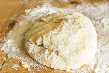 The dough made of flour and potatoes, on the plank  table