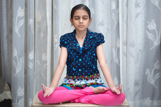 young indian girl or kid doing yoga and pranayam at such an early age for a healthy and peacful lifestyle