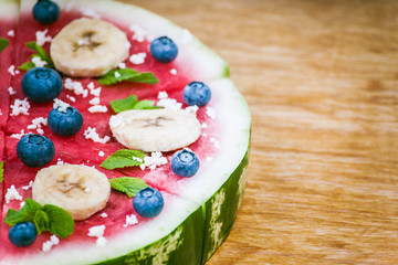 Watermelon pizza on wood