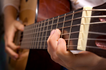 Fototapeta na wymiar Close-up view of guitar and musician's hands