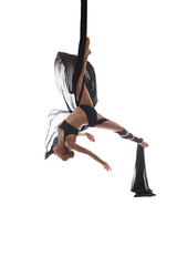 Aerial silks. Flexible dancer posing upside down