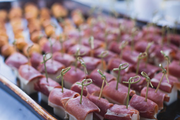 Beautifully decorated catering banquet table with different food snacks and appetizers with sandwich, caviar, fresh fruits on corporate birthday party event or wedding celebration 