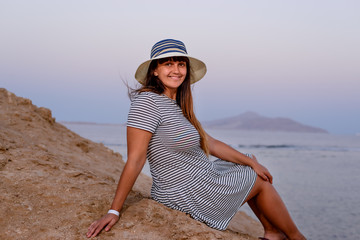 Pretty Woman in Beach Hat Smiling at the Camera