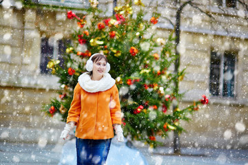 Cheerful young woman in Paris on a winter day