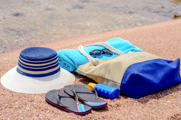 Assorted beach accessories on the sand