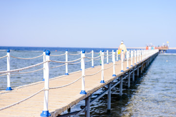 Tourists walking across a wooden pier