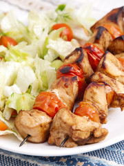 Pork skewers with salad