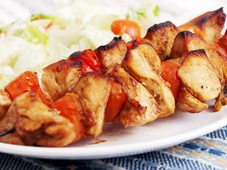 Pork skewers with salad