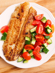 Fried white fish with salad