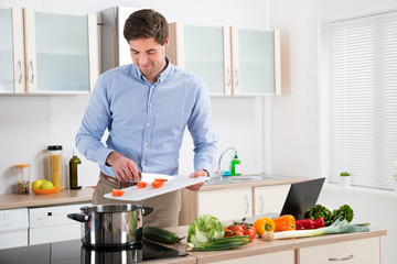 Fototapeta na wymiar Man Preparing Food In Kitchen