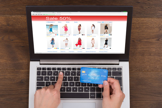 Person Shopping Online With Credit Card And Laptop